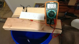 Pressure sensing apparatus attached to voltmeter and submerged into water.